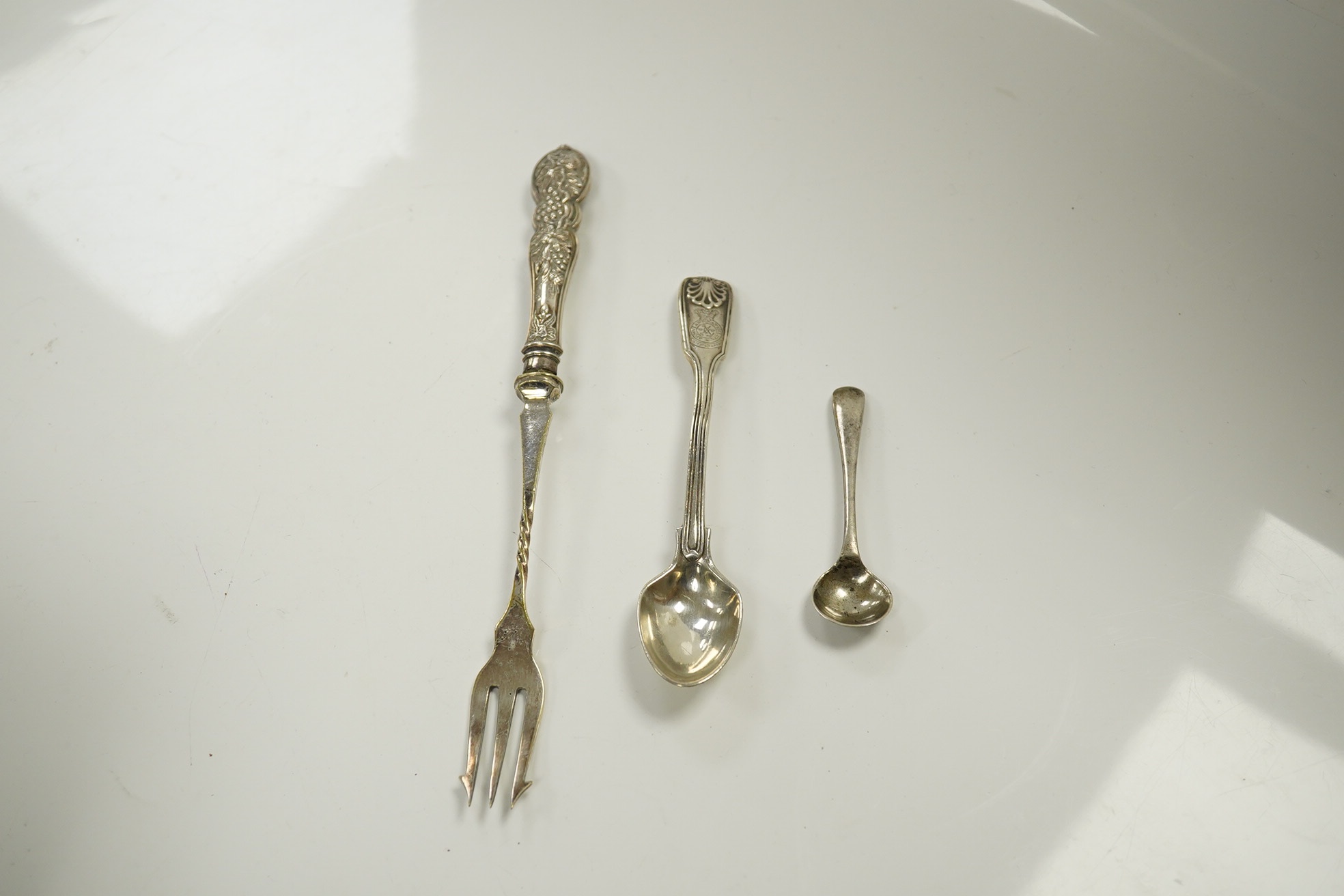 A group of assorted small silverwares including flatware, a toast rack and a pierced bon bon dish, 15.5 oz of weighable silver. Condition - fair